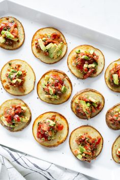 small appetizers are arranged on a white tray