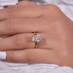 a woman's hand with a diamond ring on it