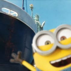 the statue of liberty is next to a minion in front of a boat with eyes