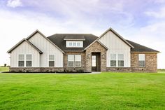 a large house sitting on top of a lush green field