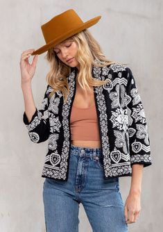 A timeless addition to any wardrobe, this unique and flattering statement jacket adds a bohemian touch to any outfit. Featuring pretty embroidered detail throughout, a versatile cropped length, and flattering three-quarter length sleeves. We love to style this jacket over a dress or with our favorite vintage jeans.  FINAL SALE Embroidered floral detail 3/4 length sleeve Cropped Collarless Open front Bohemian jacket Model is 5'9, wearing a size S.Style: I-20132W-QOG Boho Sweaters, Black Cotton Jacket, Affordable Boho, Bohemian Jackets, Statement Jacket, Couture Designers, Embroidered Jacket, Cotton Jacket, Casual Denim