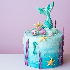 a cake decorated with blue icing and sea creatures