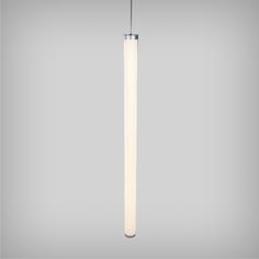 a white light hanging from the ceiling in front of a gray background with an image of a