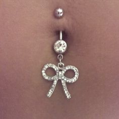 a belly piercing with a bow on it