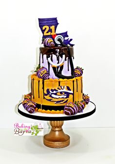 a three tiered cake decorated with purple and yellow decorations