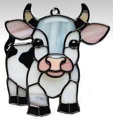 a stained glass cow ornament hanging on a wall