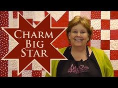 a woman standing in front of a red and white quilt with the words charm big star on it