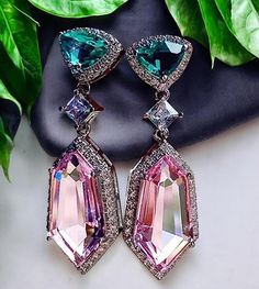 Elevate your style with these stunning dangling pink earrings, featured in rich green and soft pink hues combining elegance with a modern flair. They are precision-cut to catch and reflect light beautifully, enhancing their vibrant colors and giving the earrings a luxurious sparkle. Lightweight and comfortable, they are perfect for adding a touch of glamour to any outfit, whether it's a chic daytime look or an elegant evening ensemble. These earrings are an excellent accessory for weddings, cock Formal Pink Chandelier Earrings, Pink Crystal Drop Bridal Earrings, Formal Pink Crystal Earrings, Sparkling Pink Cubic Zirconia Earrings, Pink Sparkling Cubic Zirconia Earrings, Pink Cubic Zirconia Drop Earrings, Pink Crystal Drop Earrings For Anniversary, Pink Crystal Earrings For Formal Occasions, Pink Sparkling Crystal Earrings For Gift