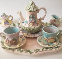 there is a tea set with cups and saucers