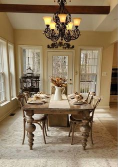 the dining room table is set with place settings for four people to sit at it