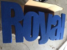 a cardboard box sitting on top of a table next to the word rondal written in blue