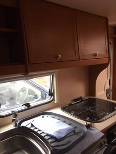 a kitchen area with sink, stove and dishwasher in an rv or camper