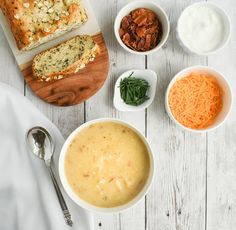 a table topped with bowls of soup and bread