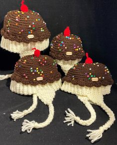 three knitted hats with chocolate frosting and sprinkles on the top