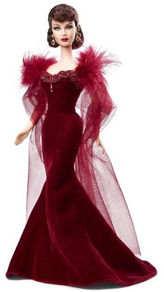 a barbie doll wearing a red gown and feathered shawl