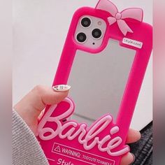 a person holding up a cell phone case with a pink bow on the front and back