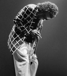 a man standing on top of a stage holding a microphone