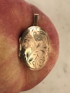 Lovely vintage 9 carat yellow gold locket pendant with beautiful foliate engraving on the front. Fully hallmarked for Birmingham 1995. Maker JAM. In excellent vintage condition.  Weight 4.10 grams.  Max length 4.8 cm Max width 2.3 cm Max depth 0.6 cm 900922 Engraved 14k Gold Oval Pendant Locket Necklace, Engraved Yellow Gold Oval Locket Necklace, Ornate Yellow Gold Hallmarked Locket Necklace, Oval Engraved Yellow Gold Locket Necklace, Antique Etched Oval Locket Necklace, Ornate Gold Locket Necklace, Antique Etched Yellow Gold Locket Necklace, Engraved Rose Gold Locket Necklace With Oval Pendant, Classic Gold Hallmarked Locket Necklace