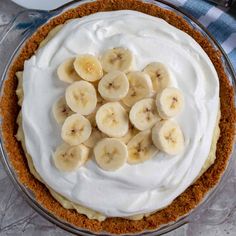 a pie topped with bananas and whipped cream