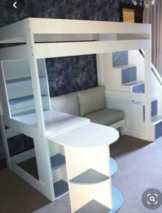 a loft bed with stairs and desk underneath