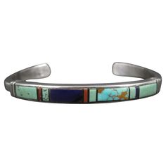 This gorgeous vintage cuff bracelet is sterling silver with turquoise, coral and lapis lazuli inlay. It is a product of Navajo silversmith Ervin Hoskie. Measurements: 1/4 of an inch wide - Inner circumference of 6 inches including the 1 inch gap Weight: 8 grams Marks: Sterling, EH Condition: Excellent Luxury Turquoise Cuff Bracelet With Inlay, Traditional Luxury Inlay Cuff Bracelet, Vintage Cuff Bracelet, Vintage Turquoise, Coral Turquoise, Lapis Lazuli, Cuff Bracelet, Cuff Bracelets, Onyx