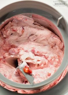 a mixing bowl filled with pink colored food