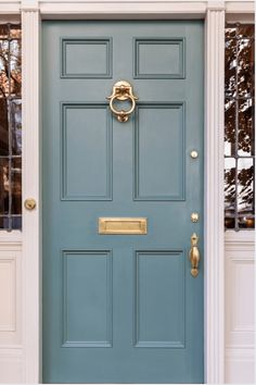 a blue front door with gold handles