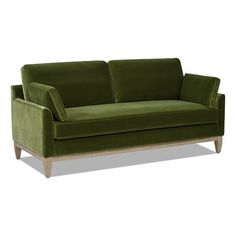 a green couch sitting on top of a white floor