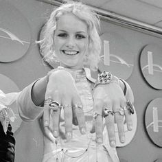 a black and white photo of a woman holding her hands out in front of the camera