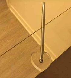 a metal object is sitting on the floor in front of a counter with wood floors