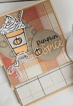 a close up of a card with a cup of coffee and the words pumpkin spice on it