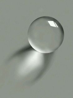 an image of two white balls on a gray surface with light coming through the top