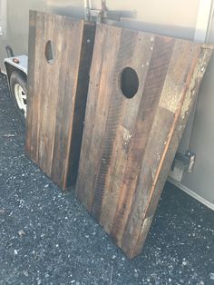 two wooden doors sitting next to each other on the ground in front of a trailer