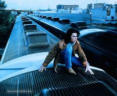 a man sitting on top of a train track