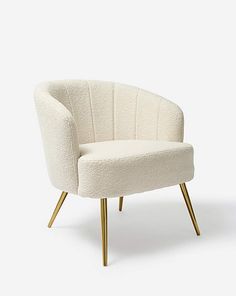 a white chair with gold legs on a white background