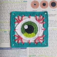 a crocheted square with an eye on it