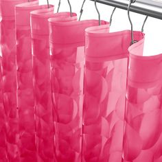 pink bags are hanging on a metal rack