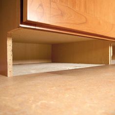 a close up view of the bottom part of a cabinet with wood grain on it