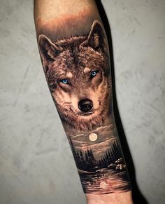 a wolf tattoo on the arm with blue eyes and trees in the background is shown