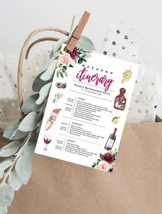 a wine tasting menu is displayed on a brown paper bag with greenery and gold confetti