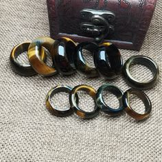 Natural Yellow Blue Tiger`s-eye Stone Ring Band Narrow Ring Natural Stone Ring material: natural stone quantity: 1pcs Thick Ring about 6.2-7.8 mm width, thickness about 3.5-4 mm. Wide Ring about 11-12 mm width, thickness about 4.2-4.8 mm. Ring 5# approx 15.7 mm Ring 6# approx 16.5 mm Ring 7# approx 17.3 mm Ring 8# approx 18.1 mm Ring 9# approx 18.9 mm Ring 10# approx 19.8 mm Ring 11# approx 20.0 mm Ring 12# approx 21.4 mm Blue Tiger Eye Stone, Thick Ring, Blue Tiger, Blue Tigers, Blue Tigers Eye, Wide Ring, Wide Rings, Tiger Eye Stone, Eye Stone