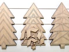 three pieces of wood are arranged in the shape of christmas trees