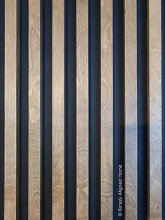 some black and brown bars are next to each other on a wooden wall with wood slats in the background