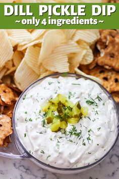 a bowl filled with dip surrounded by crackers and chips