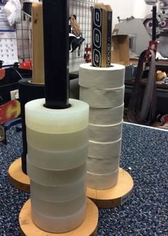 several rolls of toilet paper stacked on top of each other in a room with blue carpet