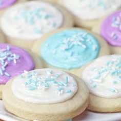 cookies with frosting and sprinkles on a plate