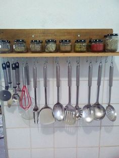 there are many spoons hanging on the wall