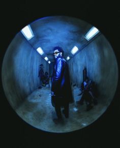 a man standing in a tunnel with other people