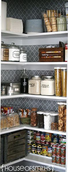 an organized pantry with white shelving and lots of food