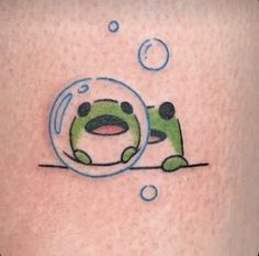 a tattoo with a frog in the center and bubbles coming out of its mouth,